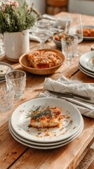 The dining table is messy after a birthday party. Plates with leftover food sit in piles. Glasses are scattered across the table. The scene shows remnants of the celebration