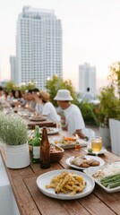 Friends sit at a table on a rooftop, sharing food and drinks. The sun sets, and tall buildings are seen in the background. Laughter fills the air as they celebrate together