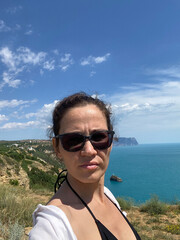 A tourist girl in shorts on a mountain trail