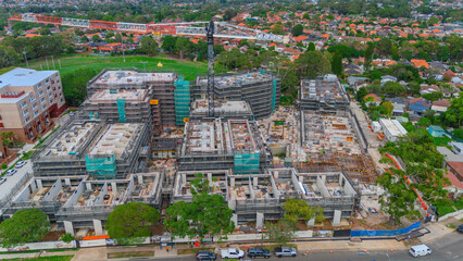 Drone panoramic aerial view of Sydney NSW Australia city Skyline and looking down on roof tops streets roads trees and parks in Suburban Sydney inner west suburbs of Burwood Ashfield Croydon Summer Hi