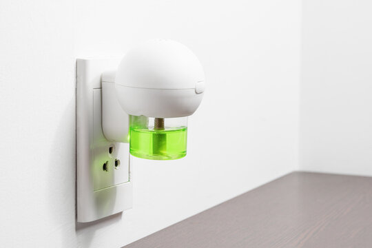 Electric device with liquid mosquito repellent into wall socket
