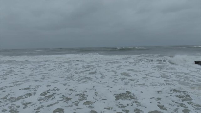 Hurricane Erin waves crashing on beach stormy ocean aerial drone view