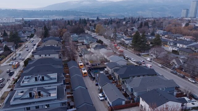 Emergency vehicles arriving at a back alley house fire