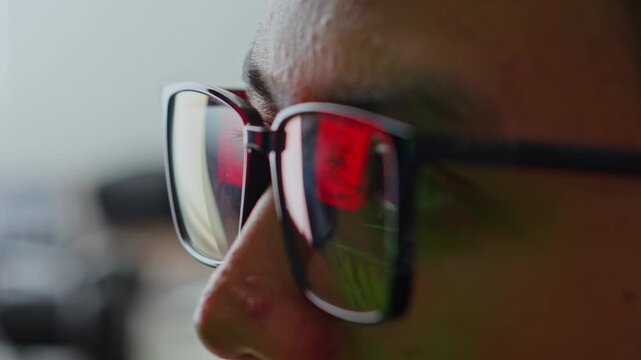Extreme close-up of hacker or IT expert's eyes with digital security alert reflected