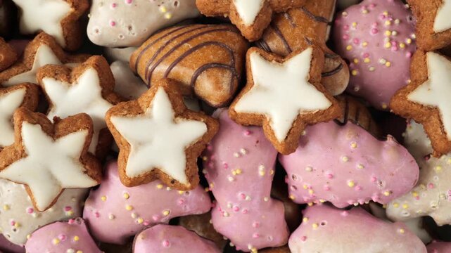 Colorful variety of glazed christmas gingerbread cookies and cinnamon stars.