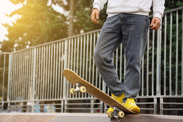 Young man with skateboard at skatepark © Pixel-Shot