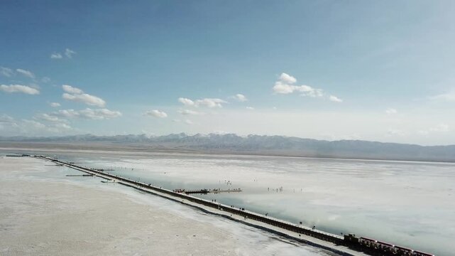 Train Crossing Chaka Salt Lake Flats with Mountain Views
