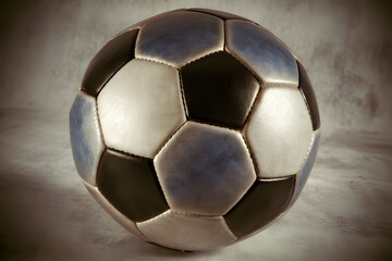 Fototapeta premium Classic black white soccer ball vintage style isolated dramatic lighting sports equipment