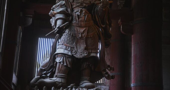 Shadowy, ancient wooden Japanese statue inside 16th century castle