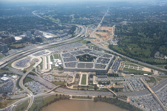 Aerial view of the Pentagon complex with surrounding roads, parking and greenery. g.