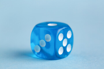 Blue game dice on color background