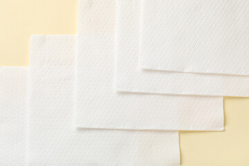 Fototapeta premium Row of paper napkins on beige background