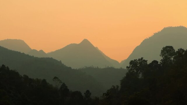 4K wide landscape shot of silhouette mountains during sunset in H&agrave; Giang , Vietnam 