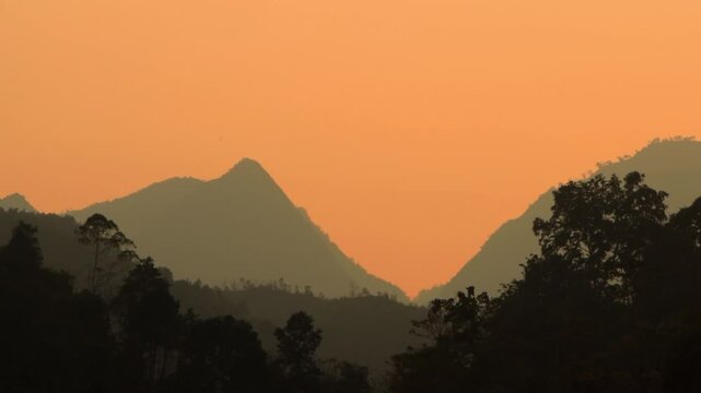 4K wide landscape shot of silhouette mountains during sunset in H&agrave; Giang , Vietnam 