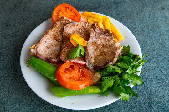 Famous Urfa meat liver, ciger wrapped by lavash with roasted chili pepper, onion and sauce in Sanliurfa, Turkey. Izgara kuzu et sis ciger. Izgara dana bonfile, cop sis, kuzu pirzola. Karisik kebap.