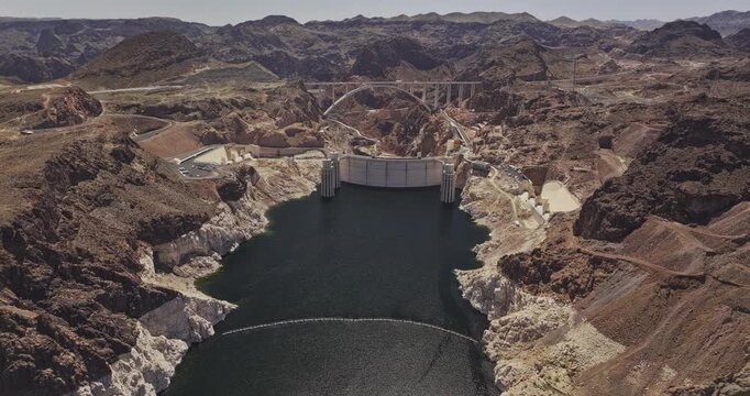 Hoover Dam Nevada Aerial v23 birds eye view flyover the terrain capturing views of rugged desert mountains and a freeway bridge arching over the canyon - Shot with Mavic 3 Pro Cine - Apr 16th 2024