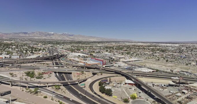 Las Vegas Nevada Aerial v171 low flyover downtown capturing traffic flow on the complex freeway interchange and views of suburb under a cloudless blue sky - Shot with Mavic 3 Pro Cine - May 2nd 2024