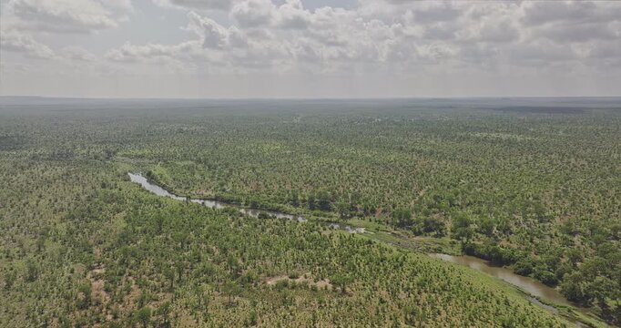 Hwange Park Zimbabwe Aerial v8 flyover capturing Deka River winding through a vast, sparsely forested savanna safari landscape and Crocodile Pools Hide - Shot with Mavic 3 Pro Cine - Jan 4th 2024