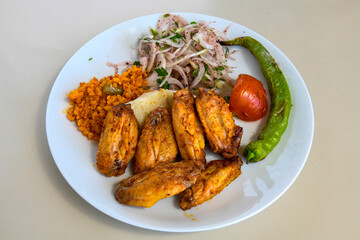 Fototapeta premium Chicken wings barbeque in a dish with BBQ sauce . Izgara tavuk kanat bonfile pirzola. Izgara tavuk gogus, pirzola, bofile. Ekmek arasi izgara tavuk durum. Firin tavuk cevirme . Grilled chicken breast