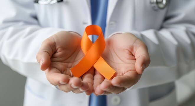 Healthcare worker holds orange ribbon to raise awareness for leukemia and other blood cancer