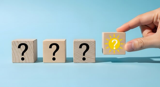 A hand replacing a question mark with an exclamation mark on wooden blocks