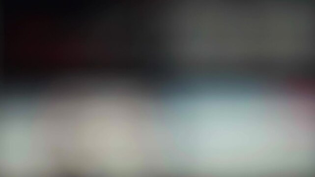 Blurred close-up of digital streaming platform interface on television screen with colorful content rows and technology concept
