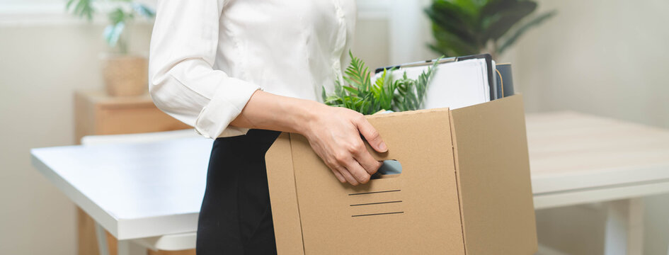 unemployed concept, employee clear her stuff at office to move out after get layoff from company in recession.