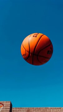 A Captivating Journey of a Basketball in Motion Against a Brilliant Blue Sky, Showcasing the Thrill of the Game and Celebrating Athleticism and Skill
