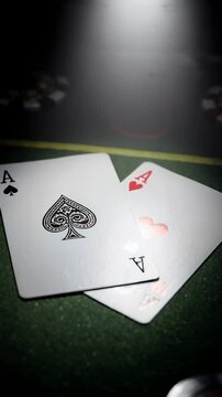 A Close-Up Look at a Pair of Aces: The Classic High-Stakes Showdown in Card Games Featuring the Iconic Ace of Spades and Ace of Hearts on a Green Felt Table