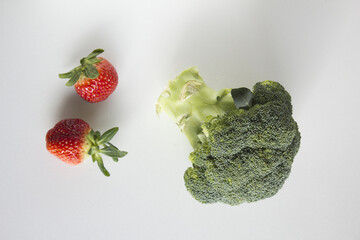 fresh strawberry and Broccoli isolated white background
