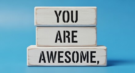 Obraz premium Inspirational wooden blocks spell out 'you are awesome' against blue background