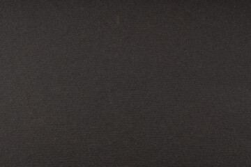 Black ribbed paper texture background with horizontal lines and dark grain surface for luxury or elegant design backdrop