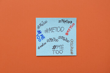 Naklejka premium Paper with hashtags METOO on orange background