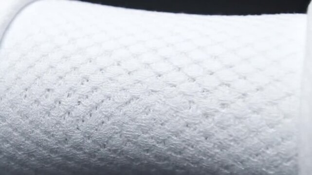 Close-up of white textured fabric surface.