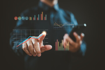 Businessman Analyzing Financial Data with Digital Graphs and Smartphone