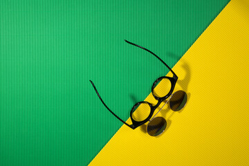 Sunglasses with double glass on a green and yellow background