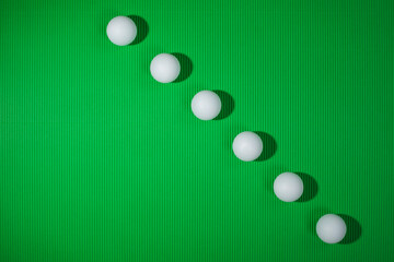 Background with white balls on a green surface