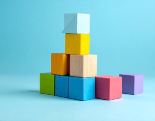 Obraz premium A stack of colorful wooden blocks on a blue background