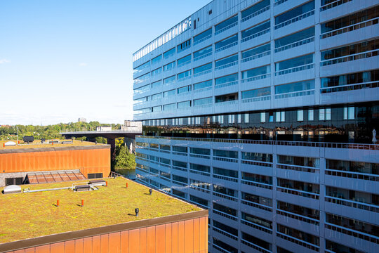 Sunlight fills courtyard as modern architecture building facade shapes urban life with sustainable design values in Stockholm Sweden