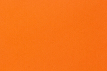 Fototapeta premium Orange solid color texture background with subtle grain surface