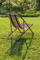A bamboo lounge chair on a grassy lawn