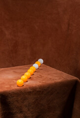 A row of white and yellow balls on a table