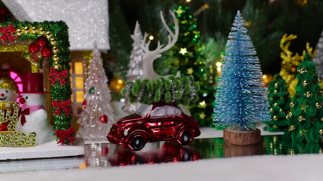 A yellow car pulls up to a Christmas house with a decorated arch with snowmen and letters in front