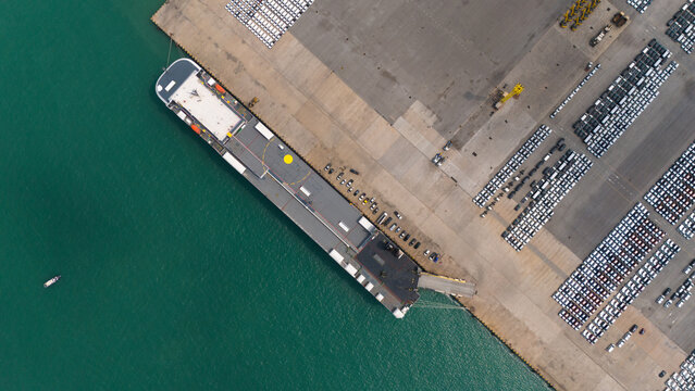 aerial view of new cars parked at the parking area of automobile factory, waiting for RORO transport of international