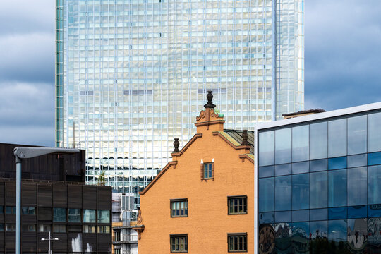 Urban city architecture building with historic brick facade in Stockholm Sweden showing skyscraper contrast against modern glass skyline under daylight