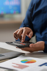 Plakat Business accounting concept, Business man using calculator with computer laptop, budget and loan paper in office. Doing finance, budgeting and tax calculation, monthly expenses. finance investment.