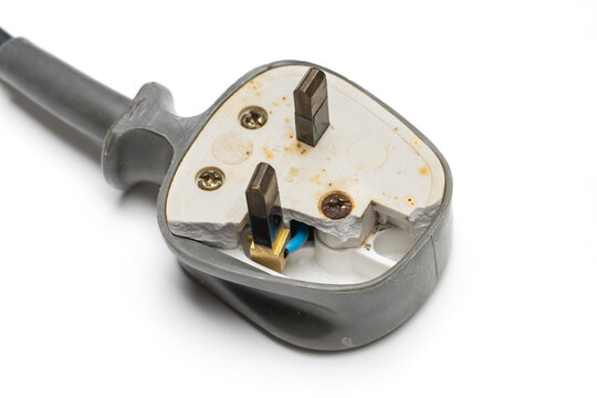 a damaged 13 ampere 3 pin UK style electrical plug top, isolated on white background. 