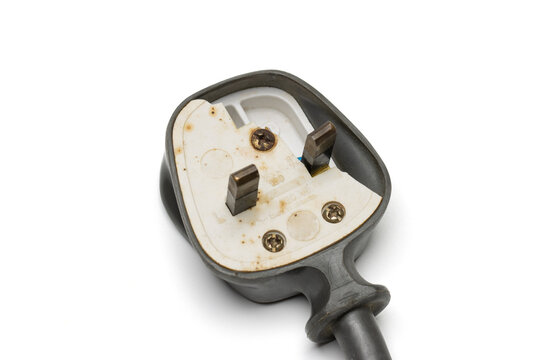 a damaged 13 ampere 3 pin UK style electrical plug top, isolated on white background. 