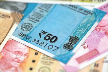 Fototapeta premium Big pile of Indian Rupees money bills banknotes close up. Lots of money of Indian INR currency cash in big bunch. Economics and business in India