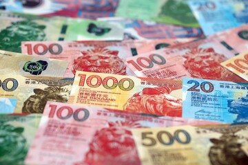 Obraz premium Big pile of Hong Kong dollars money bills banknotes close up. Lots of money of Chinese Hong Kong HKD currency cash in big bunch. Economics and business in HongKong